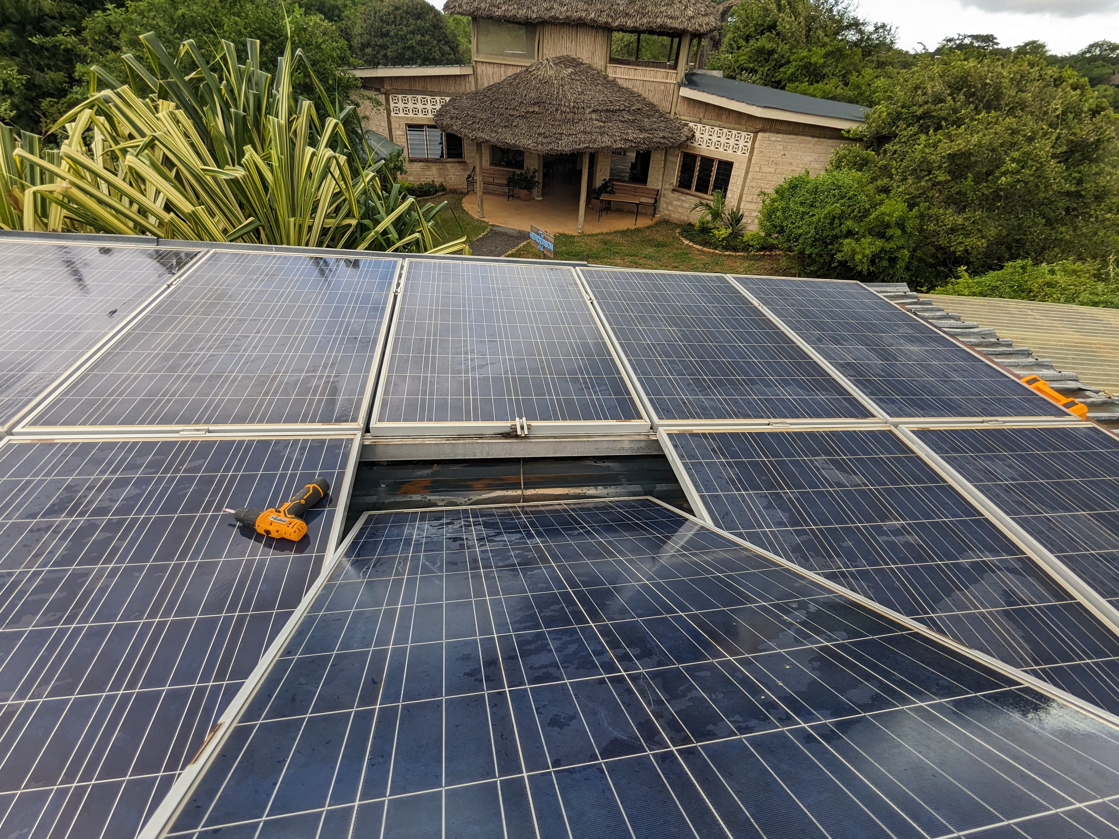 Solar installation beside coastal thatched-roof architecture